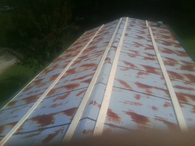 Rusted metal roof panels with new wood purlins before replacement — Storm Damage Roof Repair in Markle by Roofing Brothers